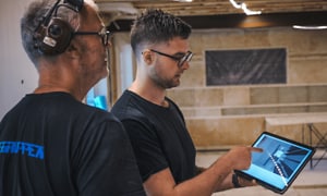 B2B - Do you run a small business - A carpenter showing a collegeau some plans on a tablet Desktop
