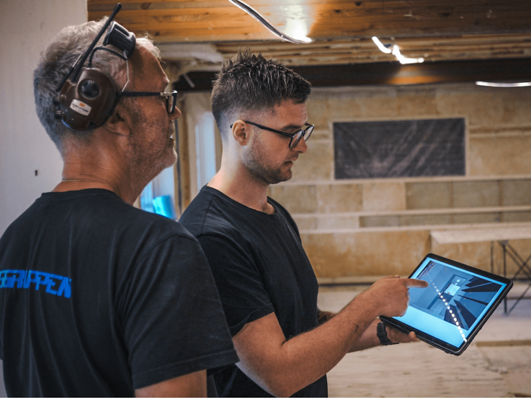 B2B - Do you run a small business - A carpenter showing a collegeau some plans on a tablet Desktop