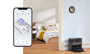 Smartphone och Roborock Max V Ultra i en dockningsstation i bakgrunden