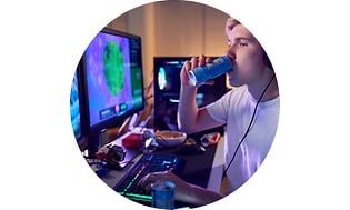 CS-Gaming insurance- Guy drinking energy drink in front of a computer