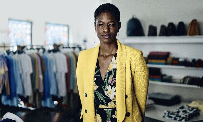 Woman in a yellow blazer in a clothing store