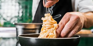 Chef plating cooked pasta