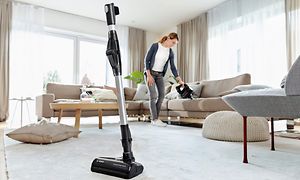 Bosch - Vacuum cleaners - Bosch vacuum cleaner's quick stand and woman in the background vacuum cleaning
