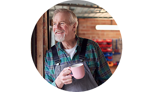 Old man looking out the window with a coffee in his hand