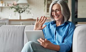 Woman smiling at tablet