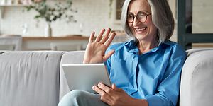 Woman smiling at tablet