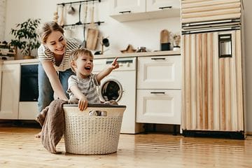 CS - Extended Warranty - A woman and child playing with a laundry basket