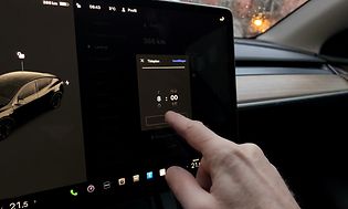 MDA - Cars and motor bikes - Man operating the touch screen in an electrical car