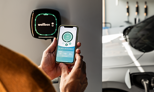 MDA - Cars and motorbikes - woman using an app in front of a charger box