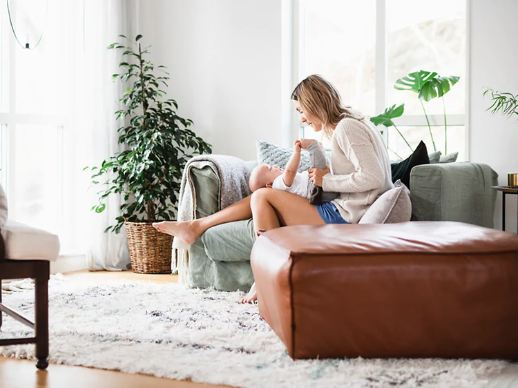 woman sitting in a couch with her child