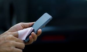 A smartphone display being cleaned