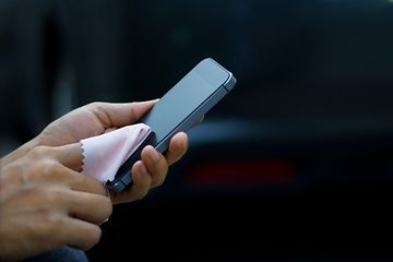 A smartphone display being cleaned