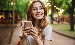 Woman smiling with phone