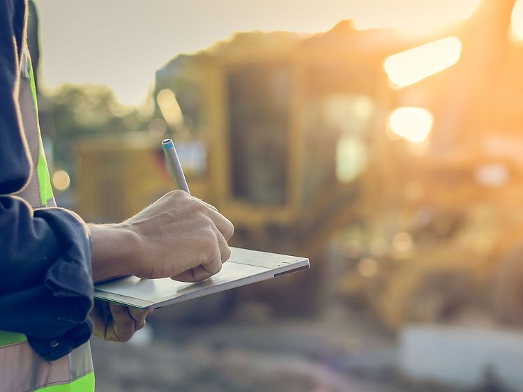 Construction worker using tablet outdoors on the work site