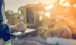 Construction worker using tablet outdoors on the work site