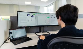 B2B - Computing - Bigger monitor - Office employee working with ultra-wide screen