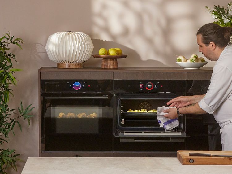 Chef takes out fried cauliflower from a Bosch accent line with air fryer