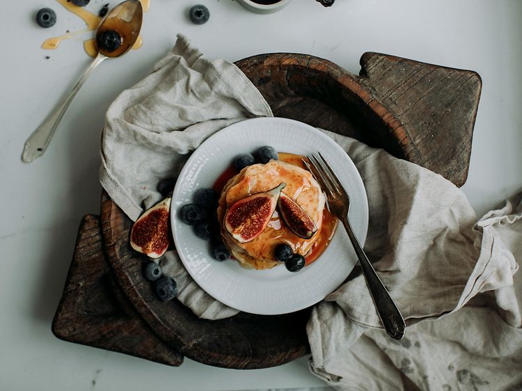 Pancake Day 2024 - Stack of pancakes with syrup, figs, and blueberries