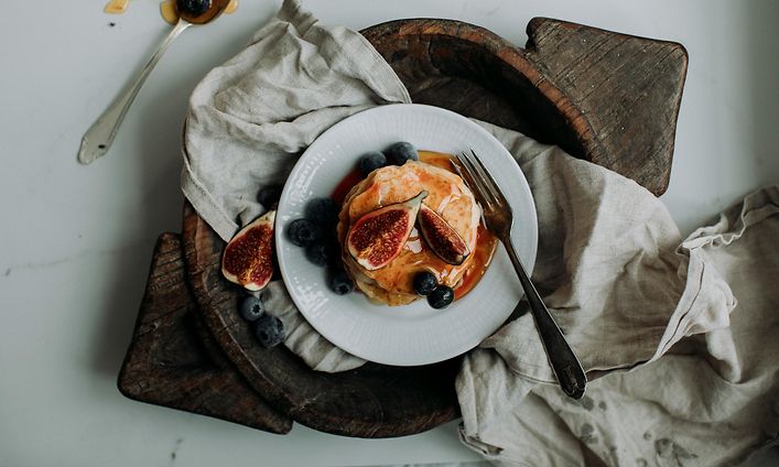 Pancake Day 2024 - Stack of pancakes with syrup, figs, and blueberries