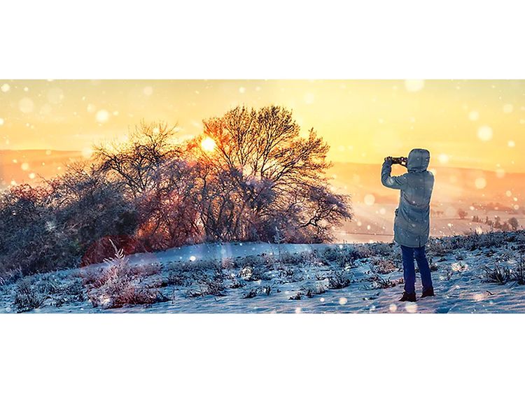 Person taking a photo in a beautiful winter landscape