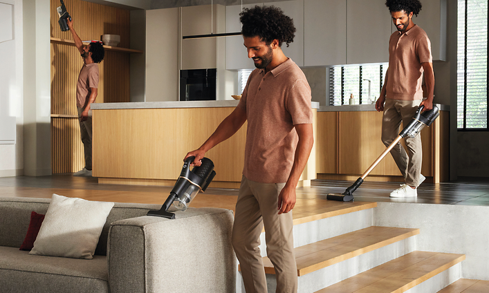 Person vacuuming a sofa with an all-round  vacuum from Miele