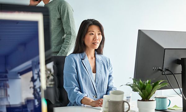 Business woman sitting in the office, working on her computer