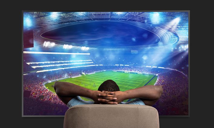 TV - Man watching soccer on a large TV