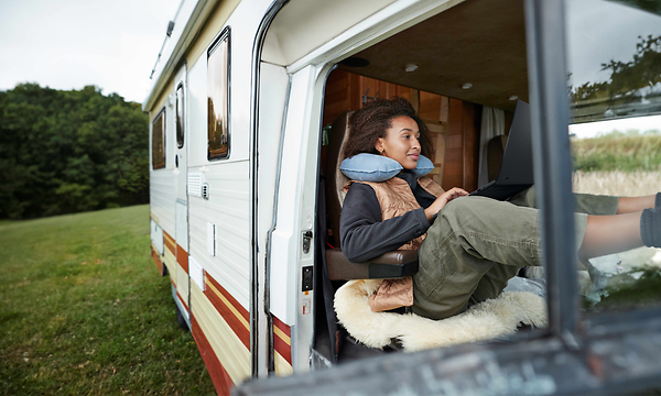 Woman in a van working with Asus ProArt P16 H7606 laptop on her lap