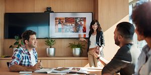 B2B - CS - Woman holding a presentation where contents is shown on meeting room TV