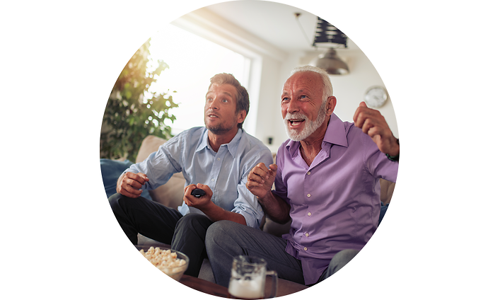 Two men in coach watching TV