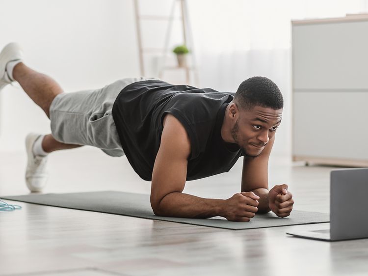 Man working out from home on his yoga mat