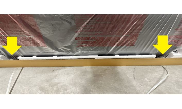 TV in package with yellow arrows that point to where to grip TV