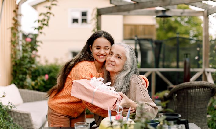 Younger woman hugging older one