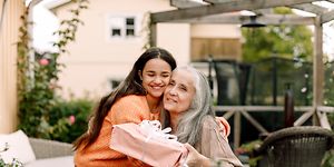 Younger woman hugging older one