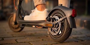 Close up of the test winner Ninebot Segway Electric Scooter being used by a man 