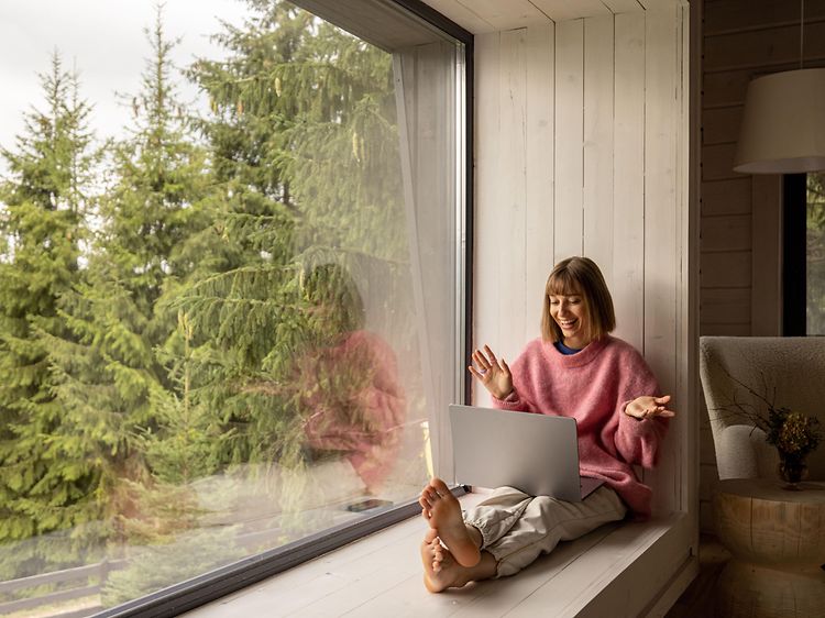 Woman with laptop in cabin