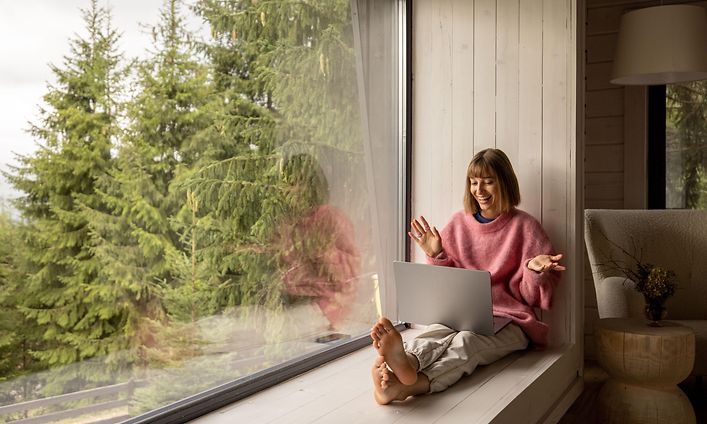 Woman with laptop in cabin