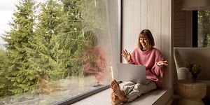 Woman with laptop in cabin
