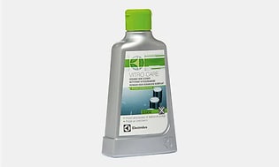 Rengöringsmedel för induktionshäll, vitro care. En grå flaska med gröna detaljer och grön kork. 