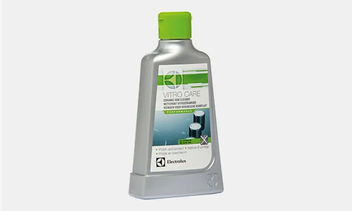 Rengöringsmedel för induktionshäll, vitro care. En grå flaska med gröna detaljer och grön kork.