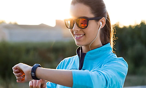 En kvinna ser på sin smartwatch under träningspasset.